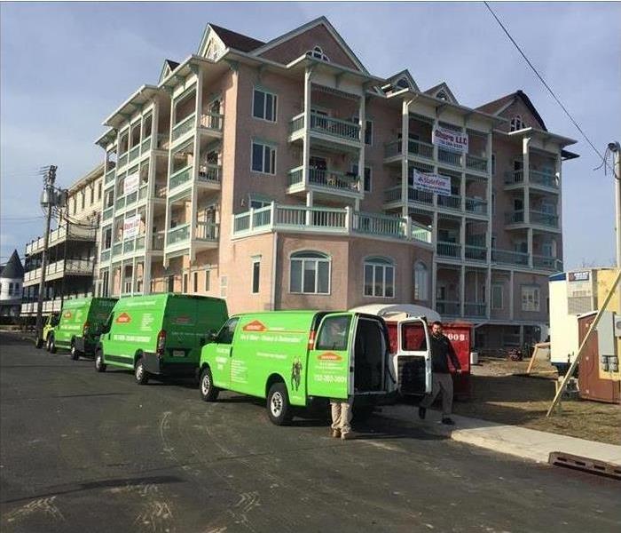 SERVPRO vehicles parked outside apartment building